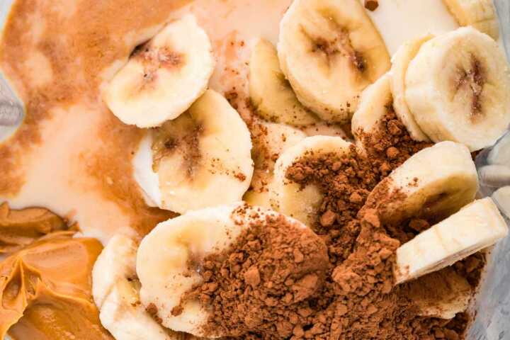 overhead view of ingredients to make chocolate peanut butter banana smoothie