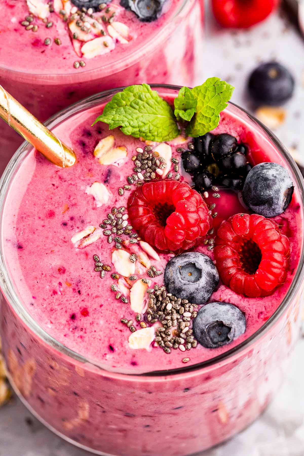 overhead close up view of glass with mixed berry smoothie