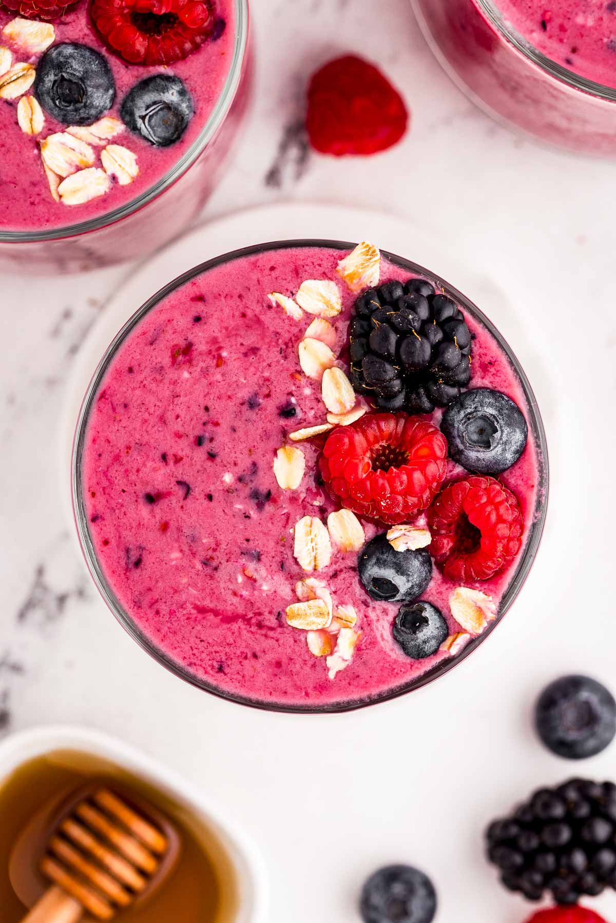 overhead view of glass filled with mixed berry smoothie and garnished