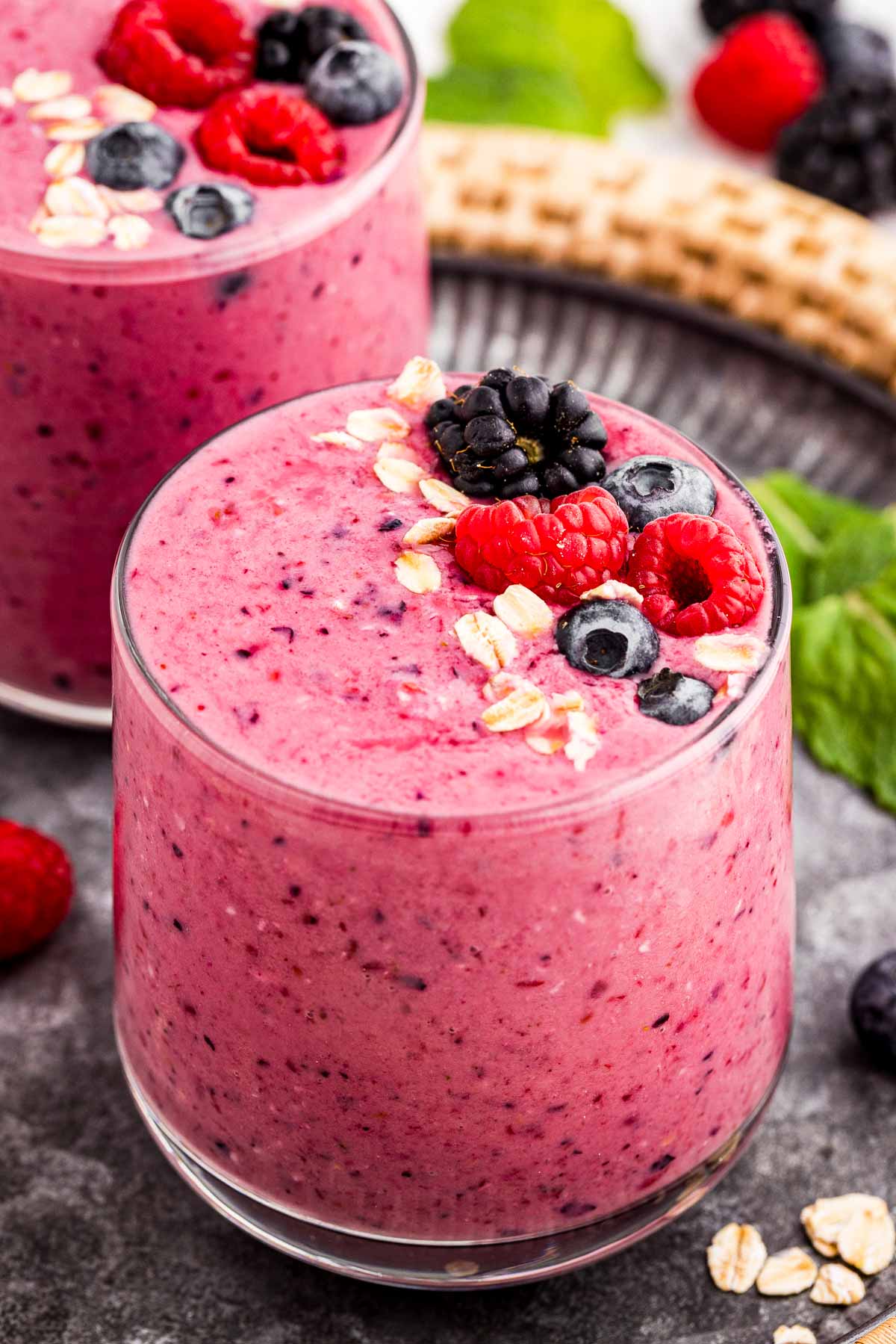 frontal view of glasses of mixed berry smoothie on serving tray