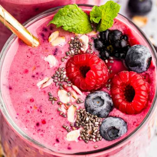 overhead close up view of glass with mixed berry smoothie