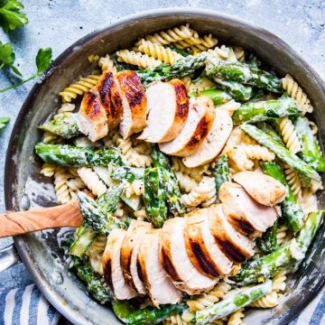 chicken asparagus pasta in creamy sauce in a skillet