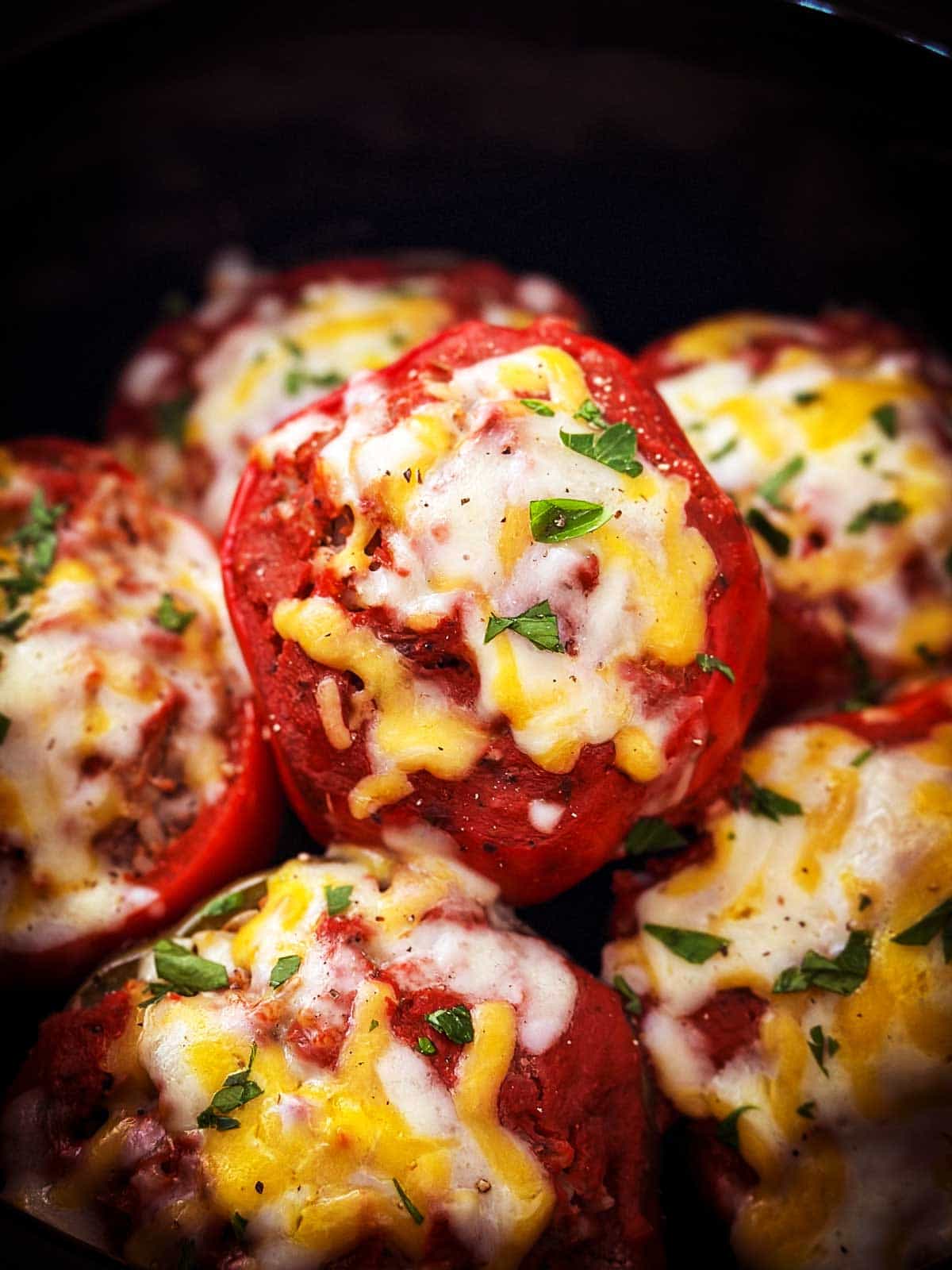 frontal closeup view of stuffed peppers in crockpot