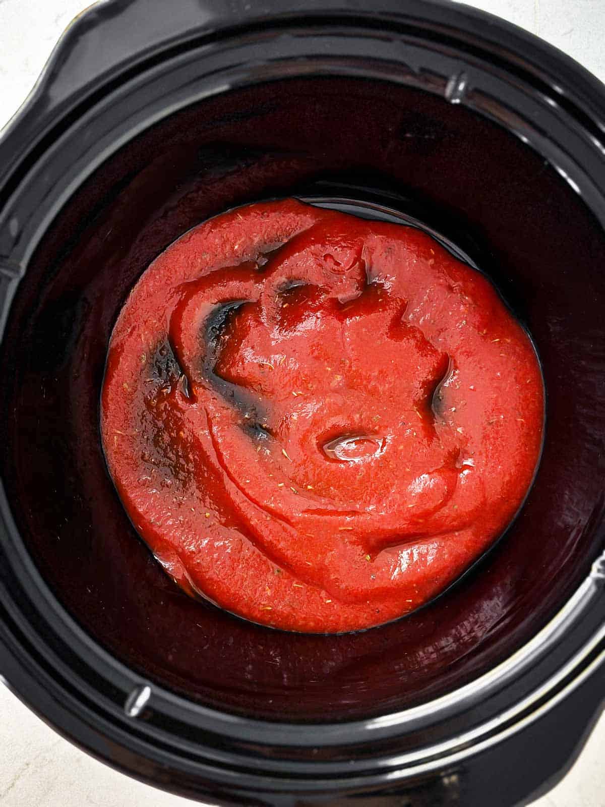 overhead view of tomato sauce in crock pot