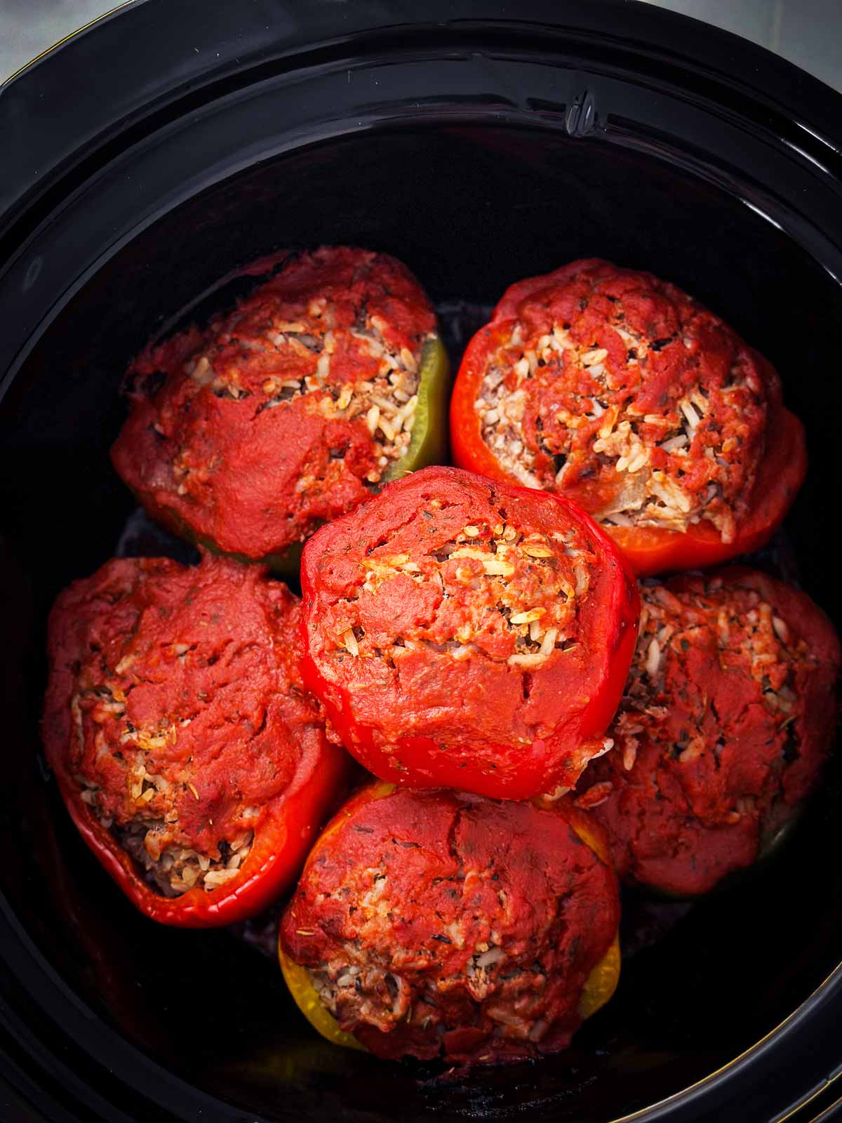 overhead view of cooked stuffed peppers in crockpot