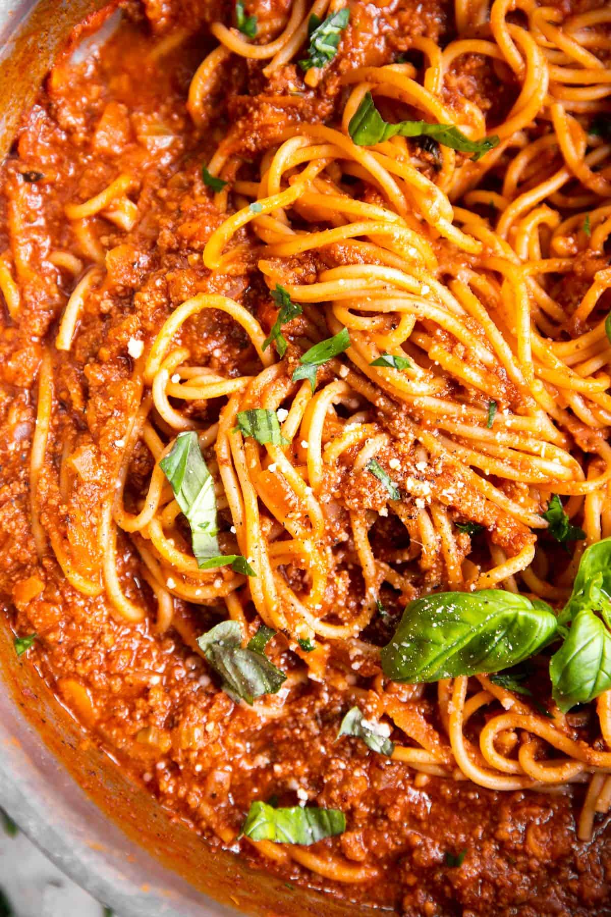 close up photo of spaghetti and meat sauce in pan