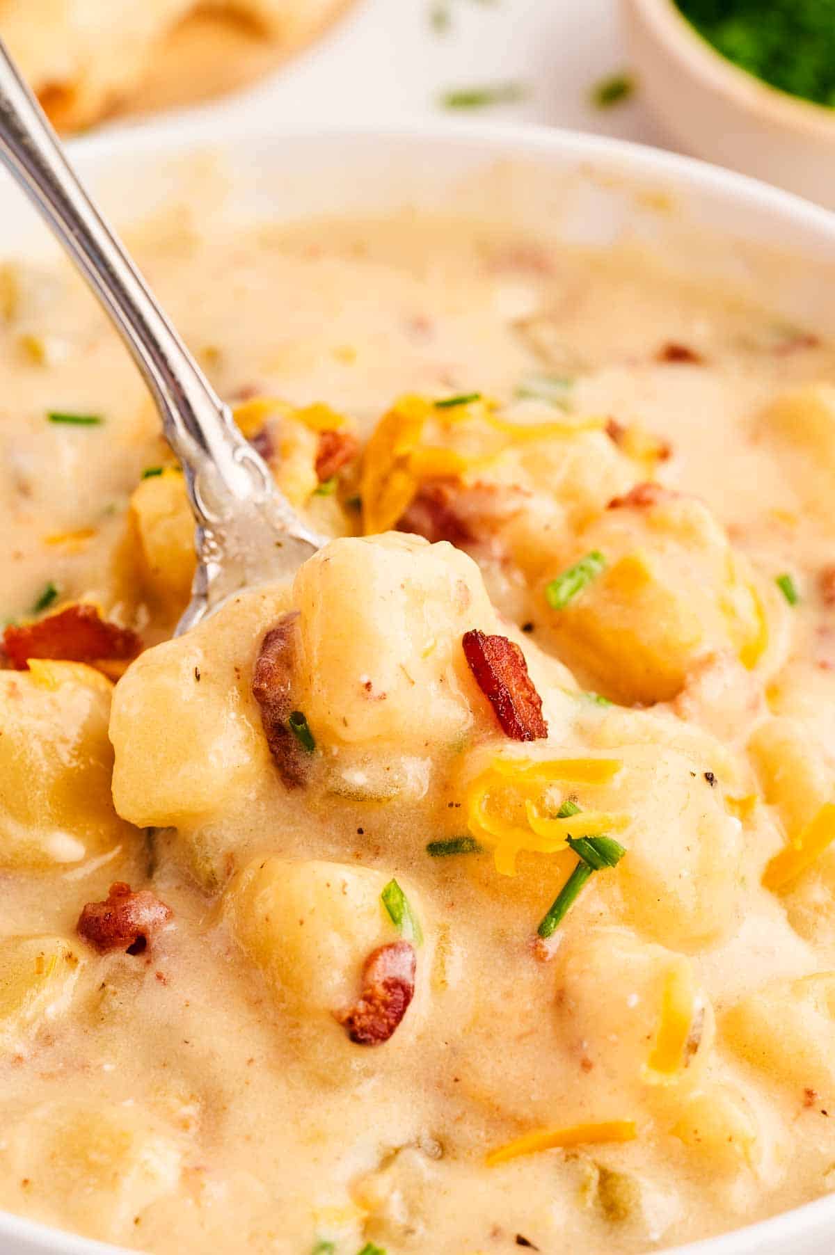 close up view of spoon stuck in potato soup