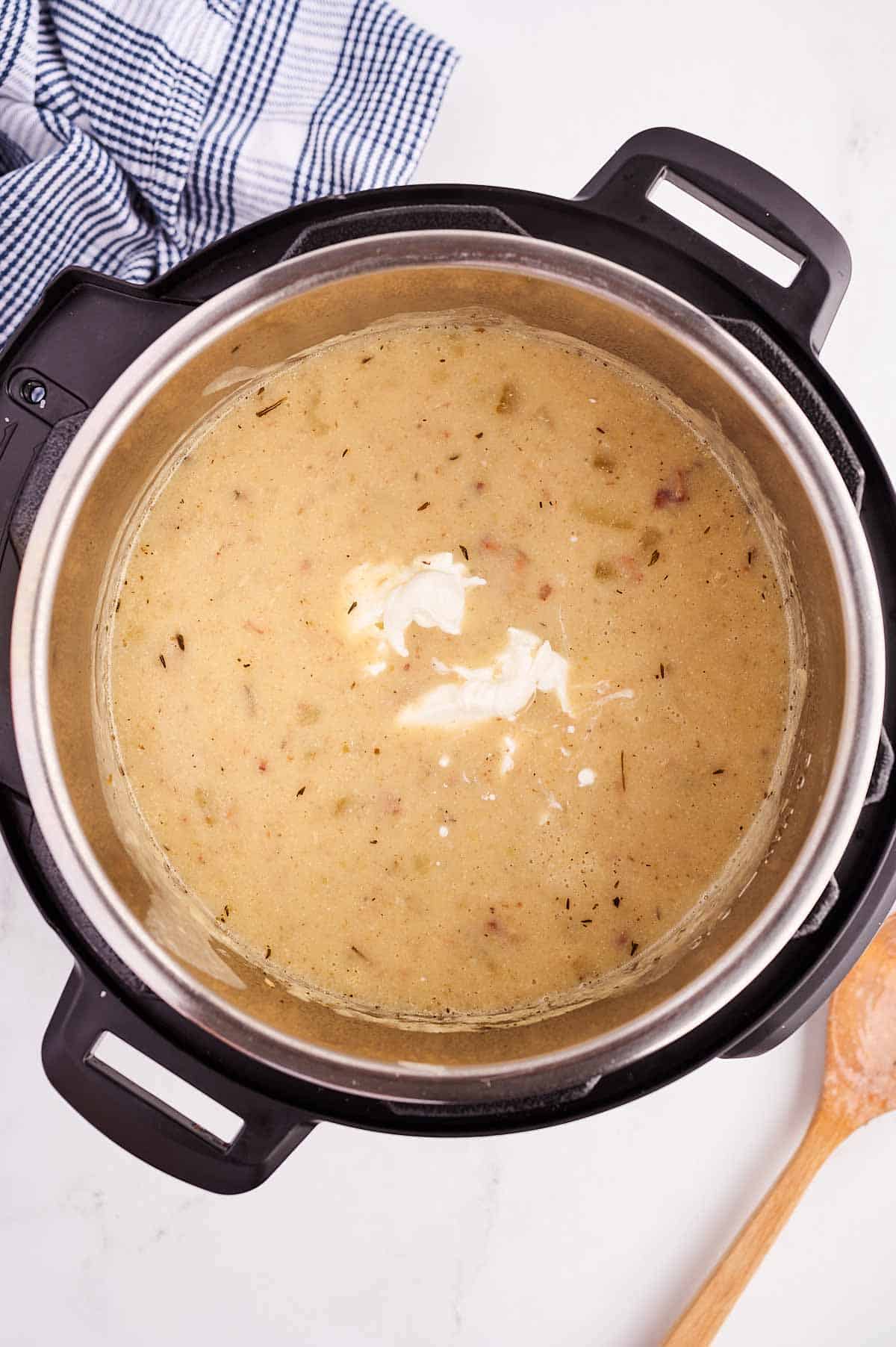 overhead view of sour cream in potato soup in instant pot