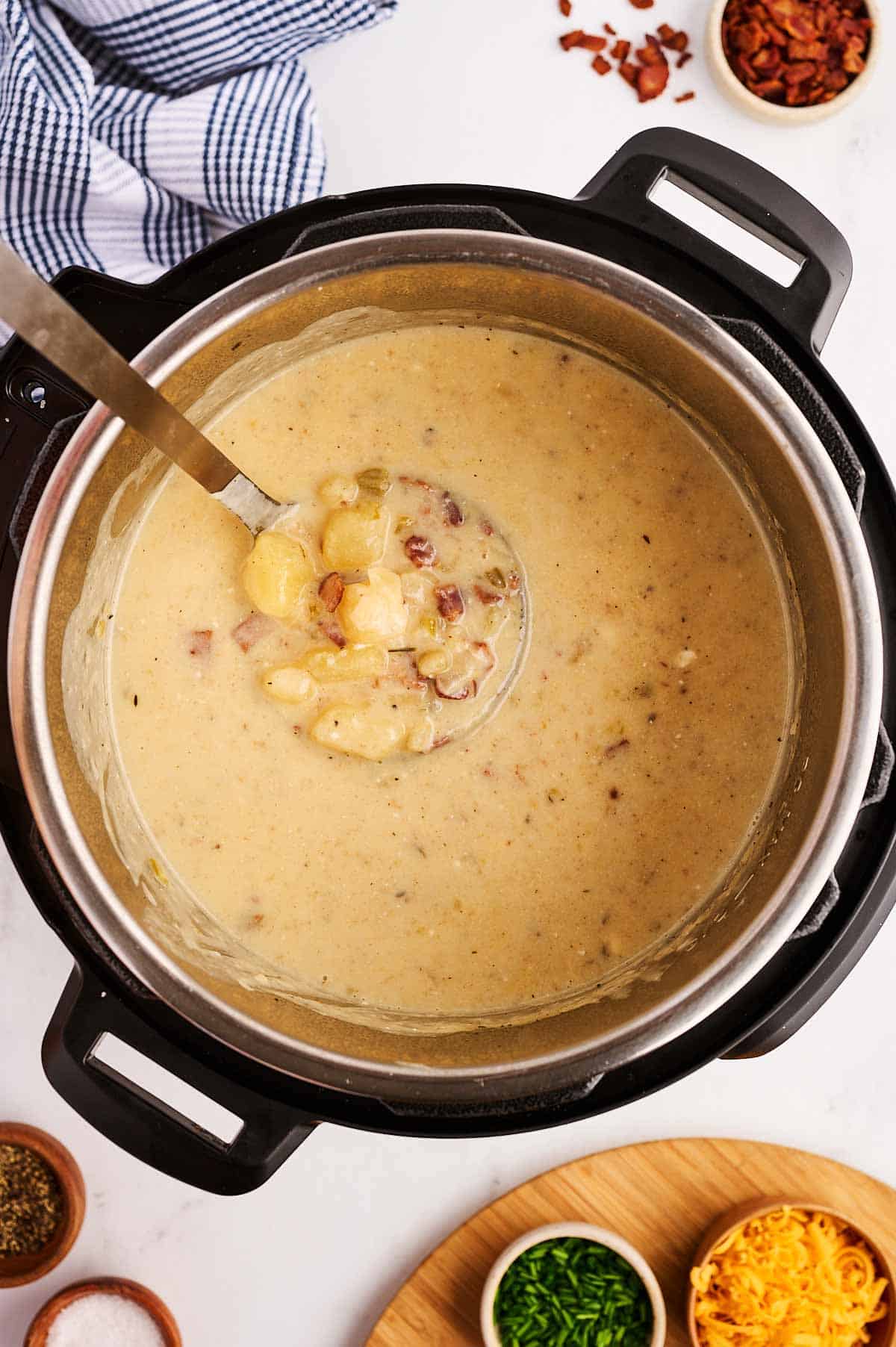 overhead view of ladle in instant pot filled with potato soup