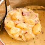 frontal view of ladle filled with potato soup inside instant pot