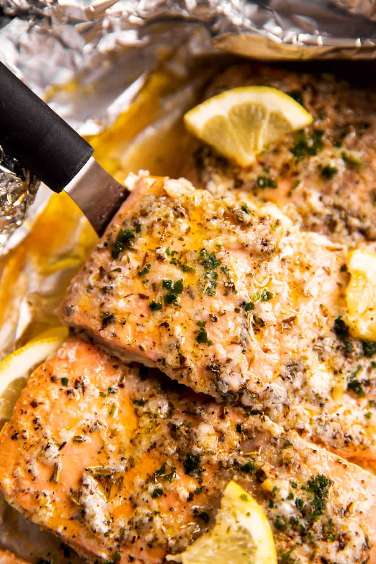 close up photo of baked salmon on lined pan