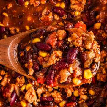 overhead view of spoon with turkey chili over crockpot