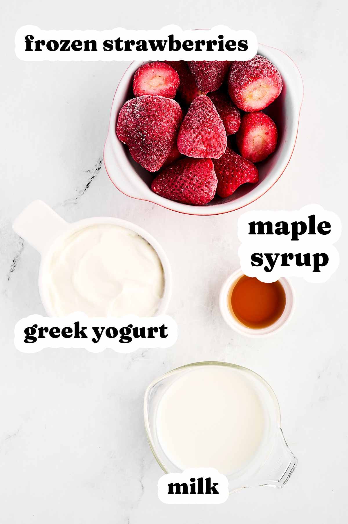 overhead view of ingredients to make strawberry yogurt smoothie with text labels