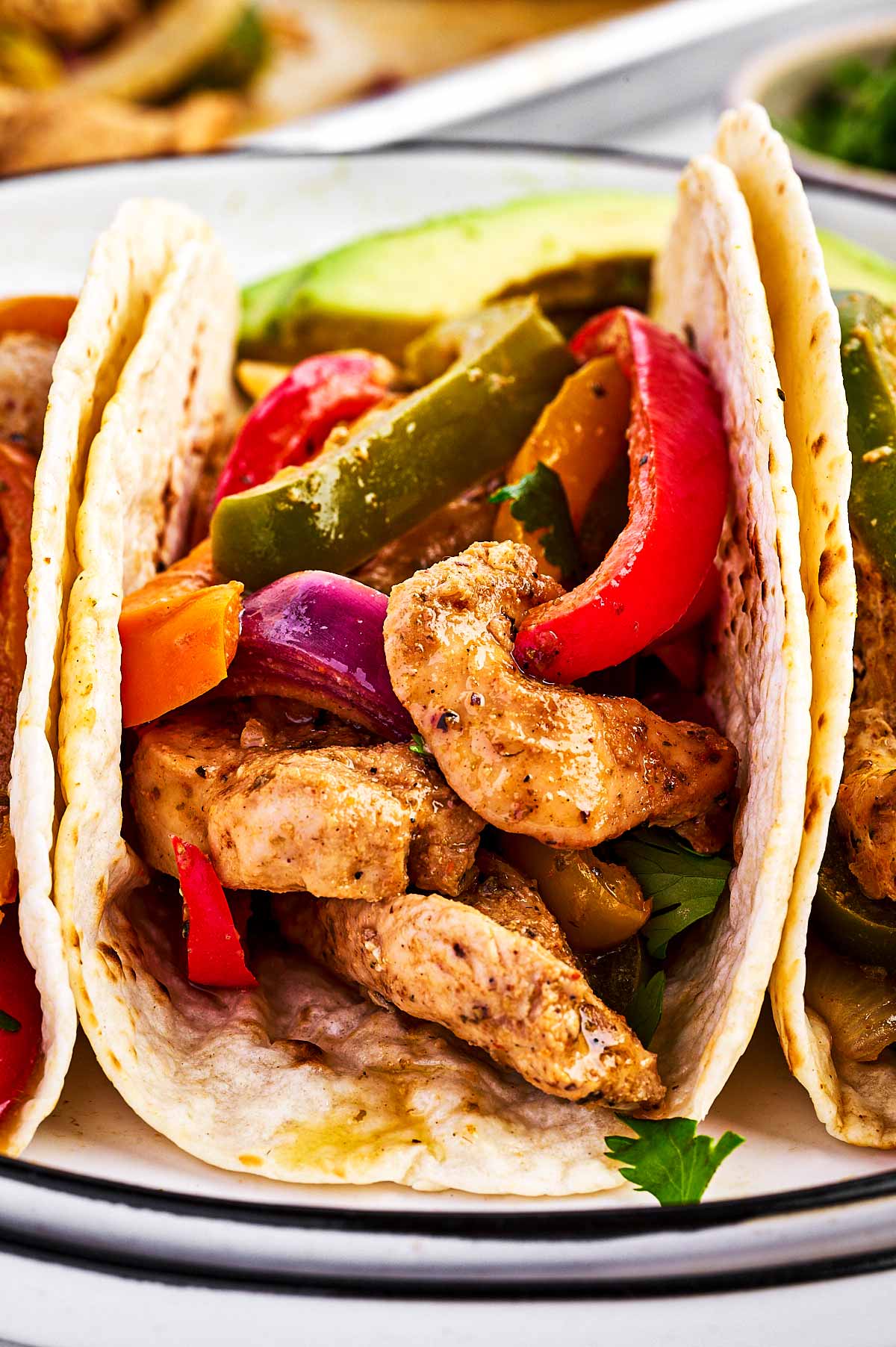 frontal view of chicken fajitas on white plate