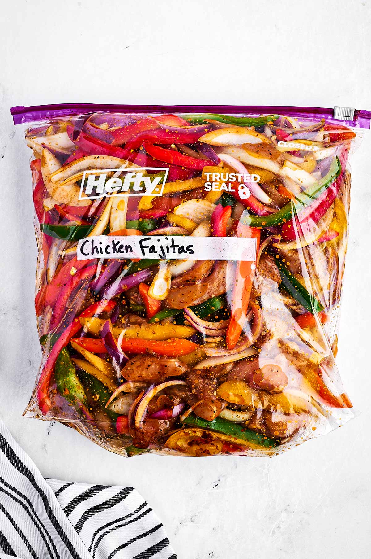 overhead view of chicken fajita mix in zip top bag labelled as "chicken fajitas"