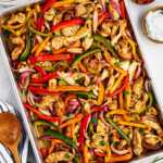 overhead view of baked chicken fajita mixture on sheet pan