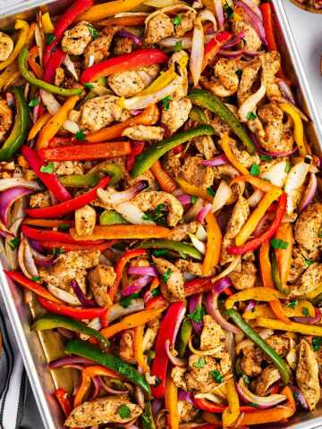 overhead view of baked chicken fajita mixture on sheet pan