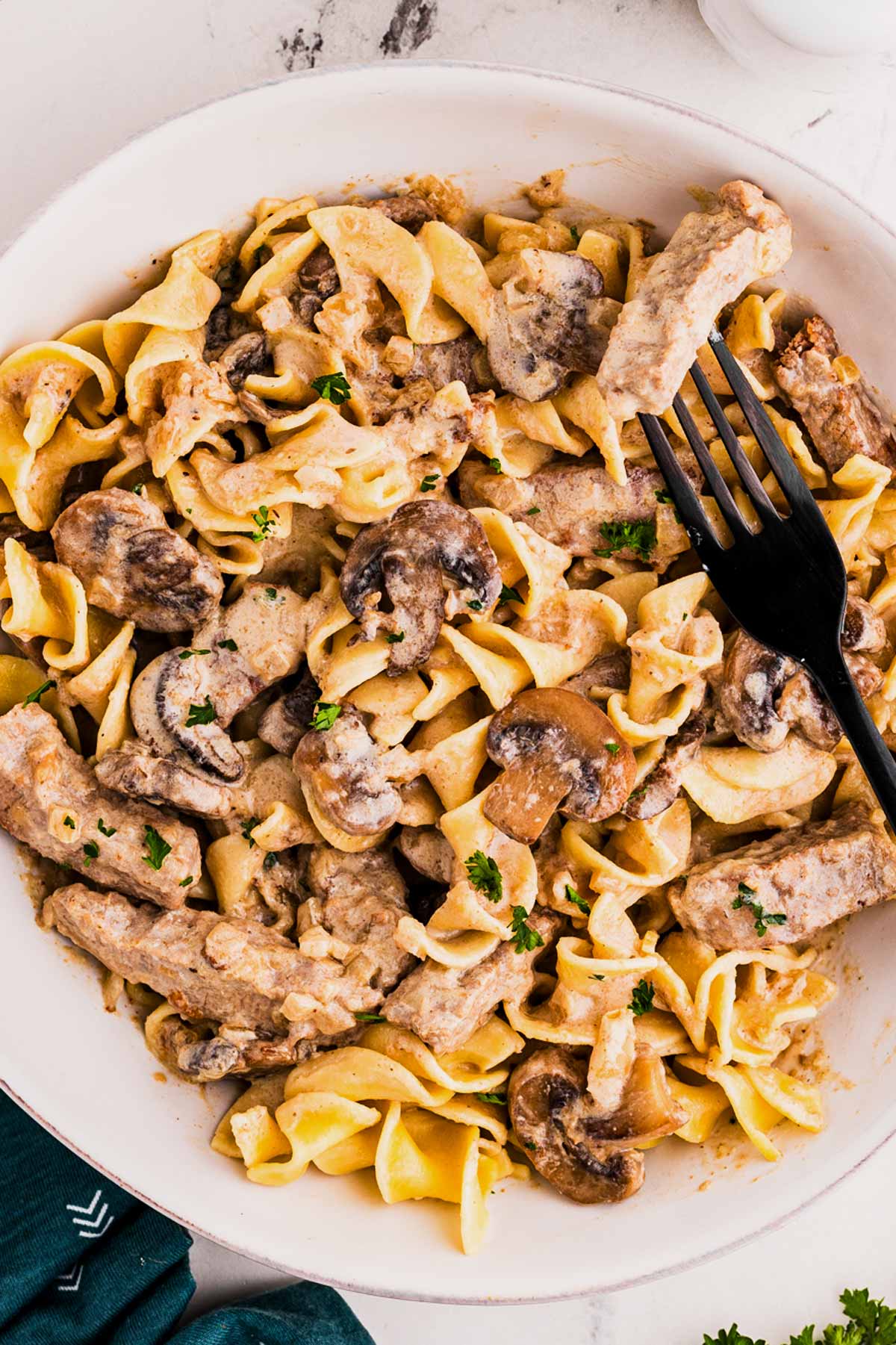 overhead view of beef stroganoff on plate with noodles