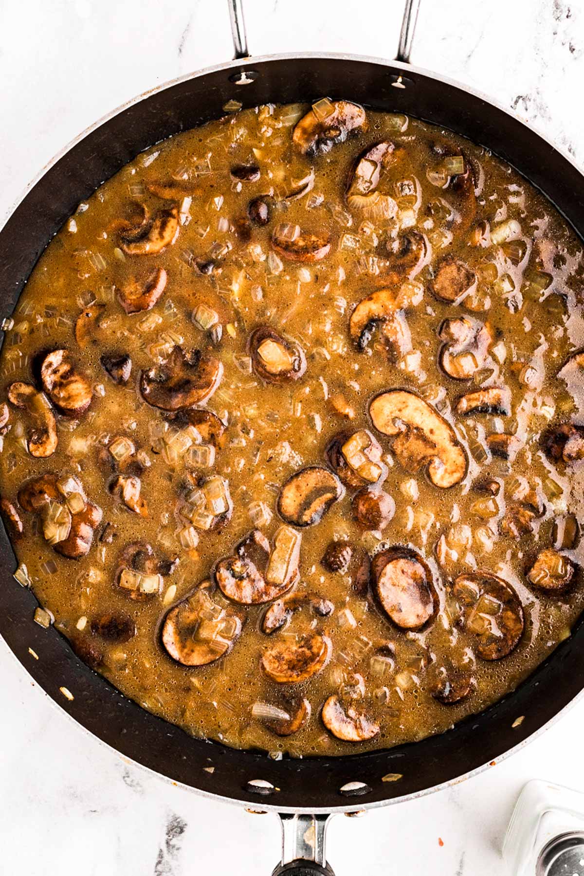 overhead view of simmering beef stroganoff in skillet