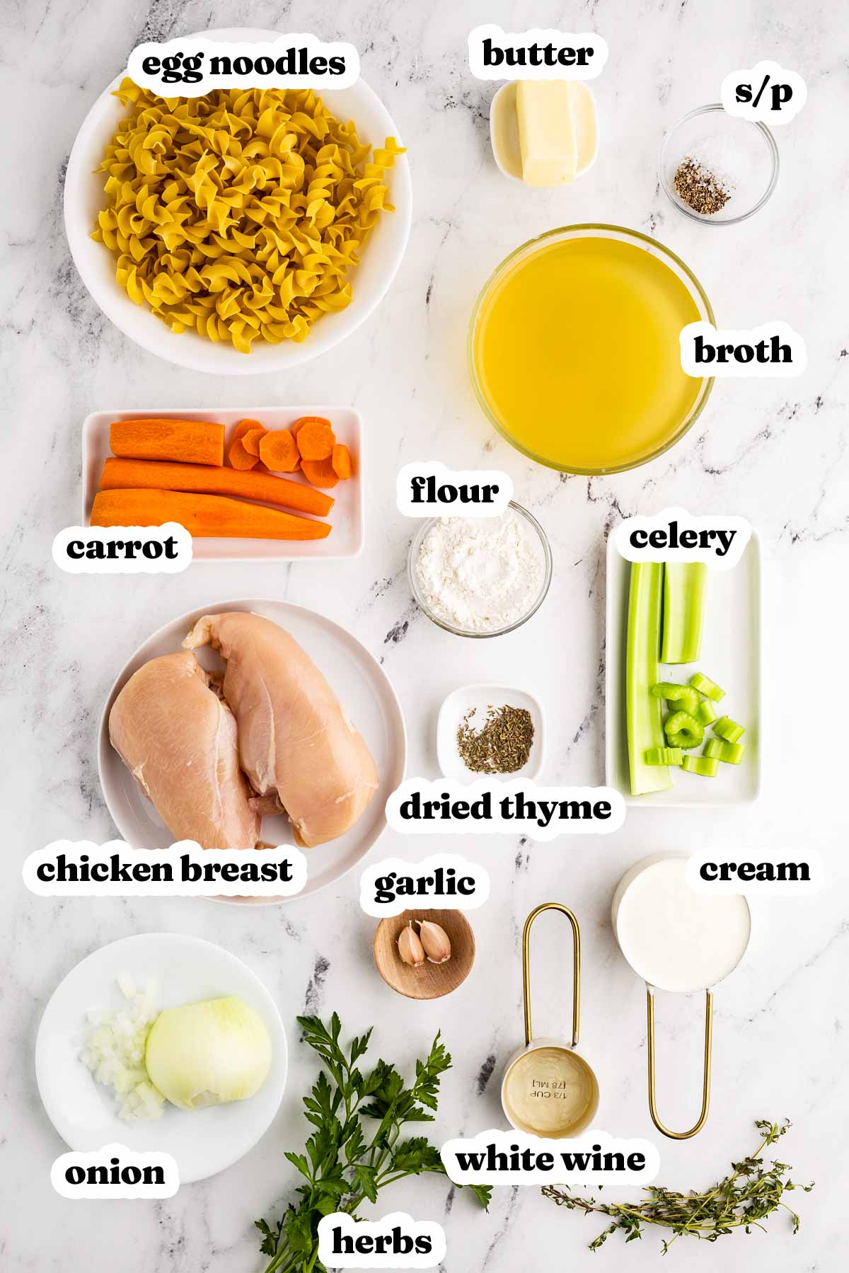 overhead view of ingredients to make creamy chicken noodle soup with text labels