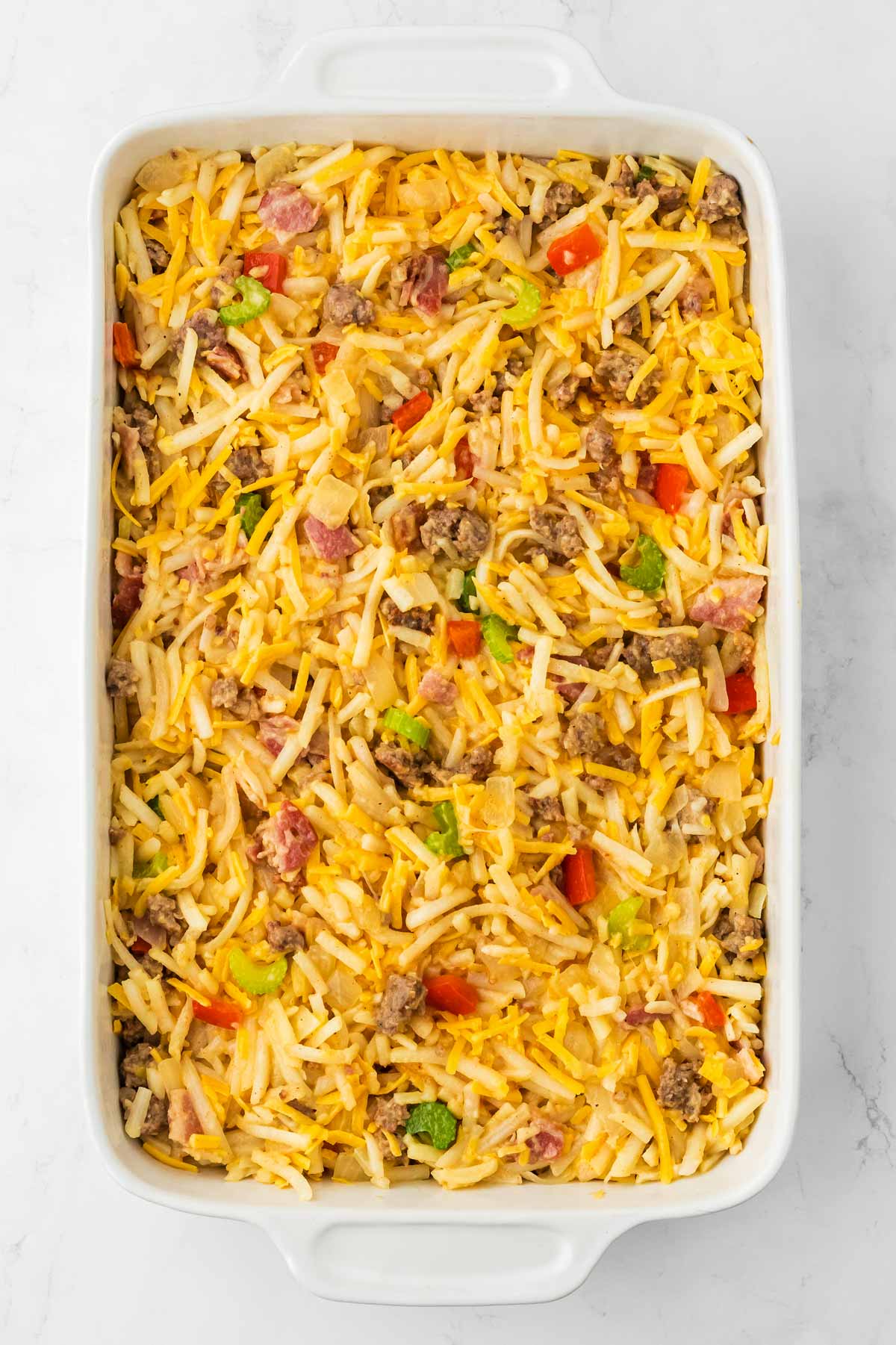 overhead view of unbaked hashbrown breakfast casserole