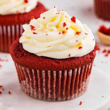 frontal angled view of red velvet cupcake with frosting