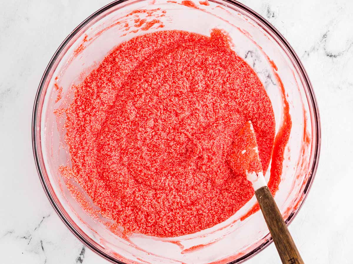 overhead view of wet ingredients for red velvet cupcakes in glass bowl