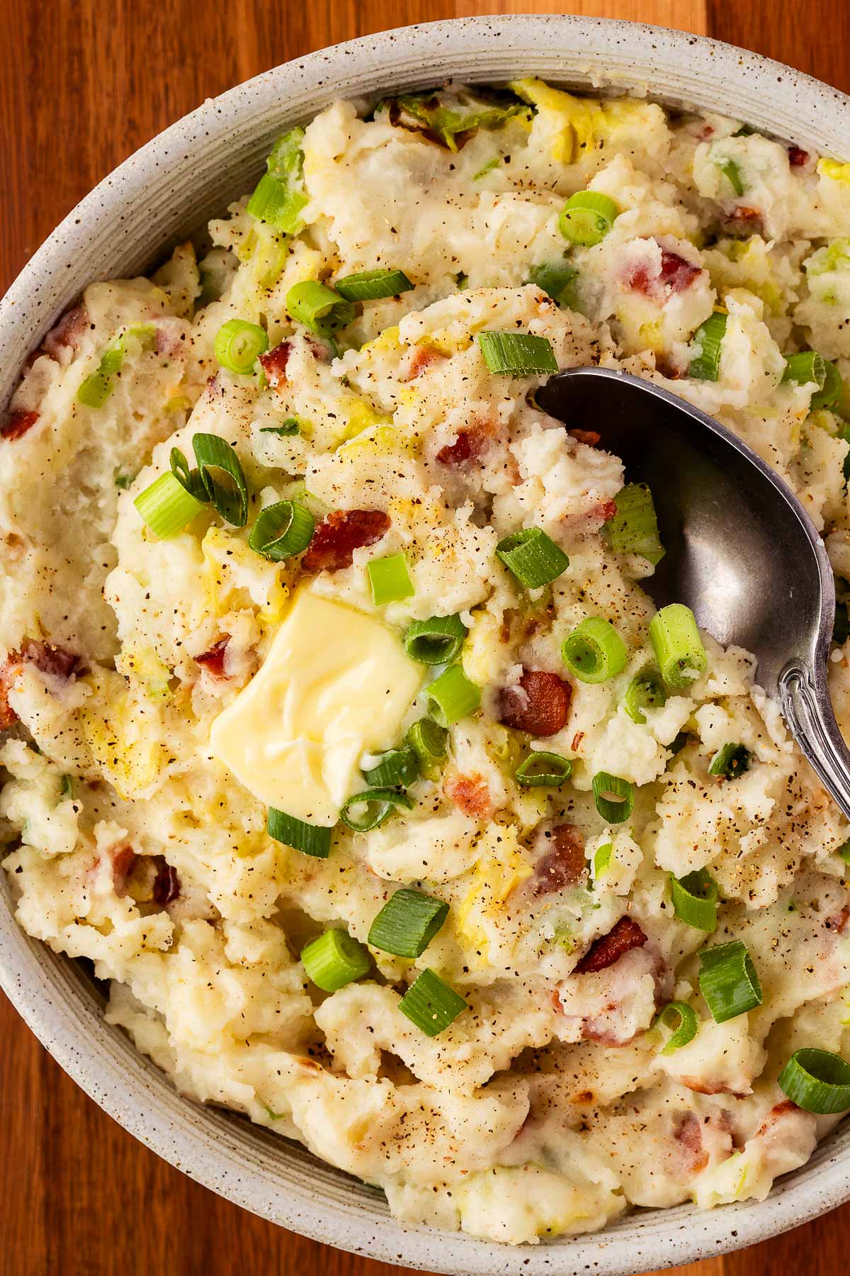 overhead view of colcannon with butter in bowl