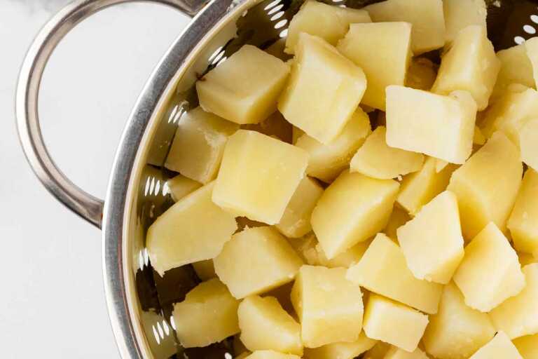 overhead view of cooked potatoes in colander