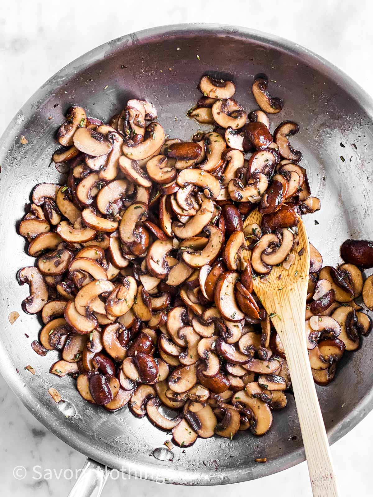 overhead view of mushrooms in skillet with garlic