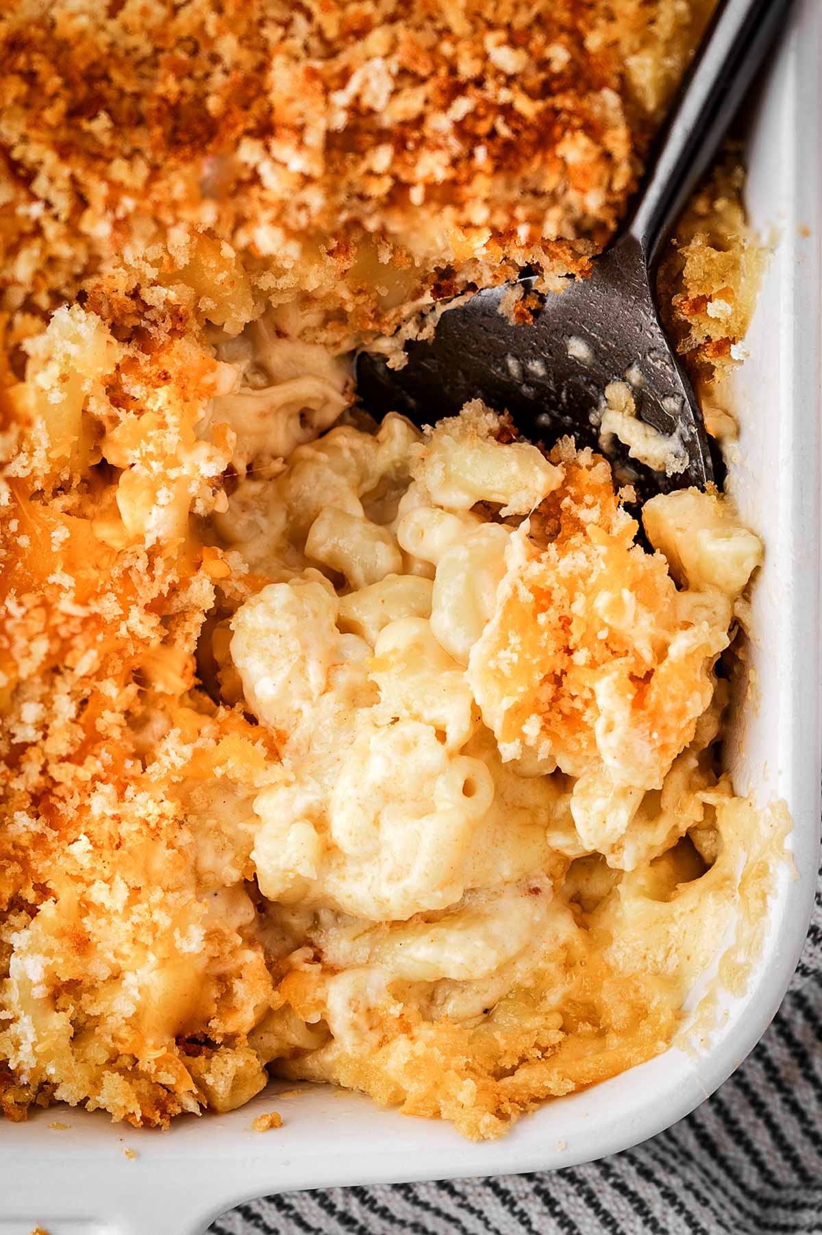 overhead close up view of scooped Mac and cheese in casserole dish