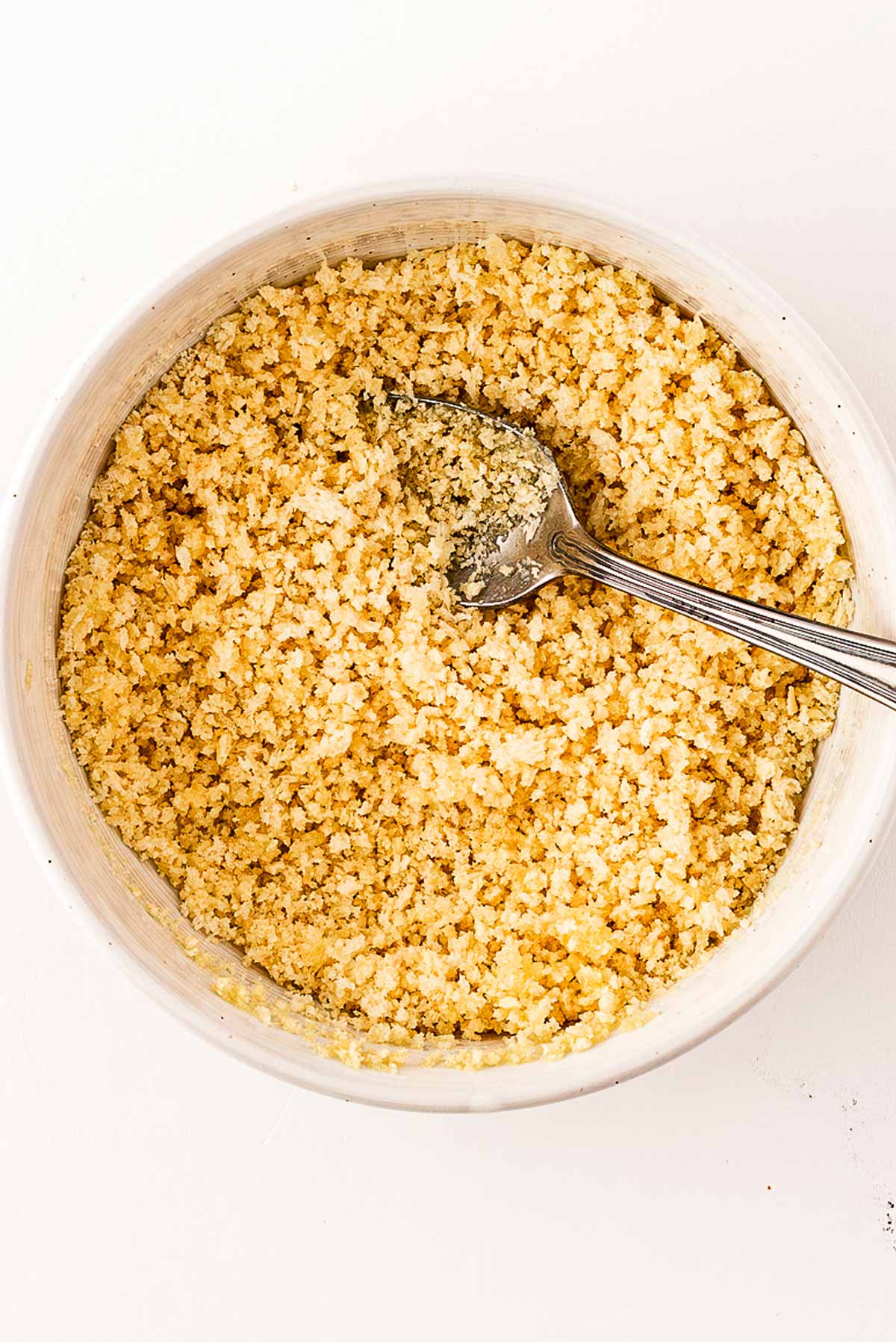 overhead view of breadcrumbs and butter in white bowl