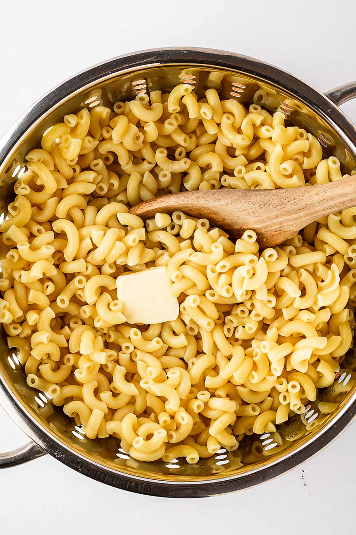 overhead view of macaroni in colander with butter