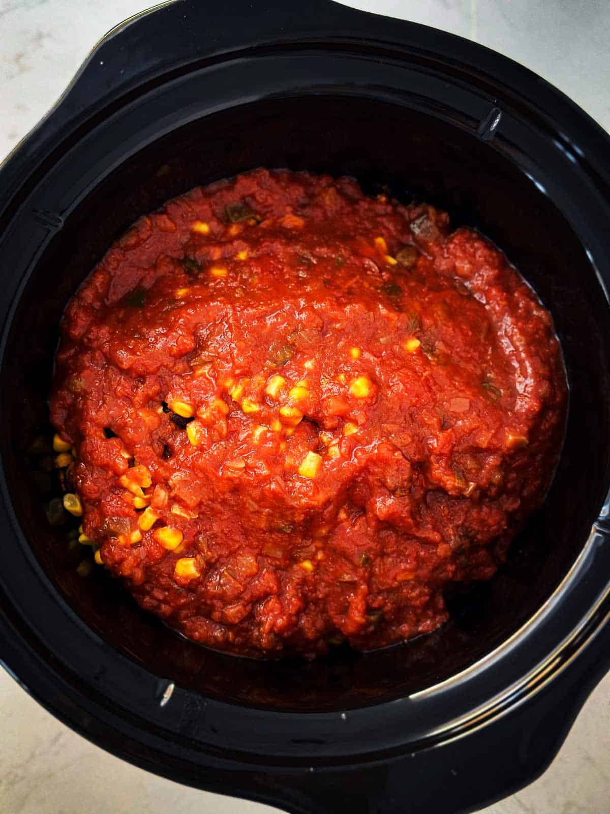 overhead view of salsa and corn in crock