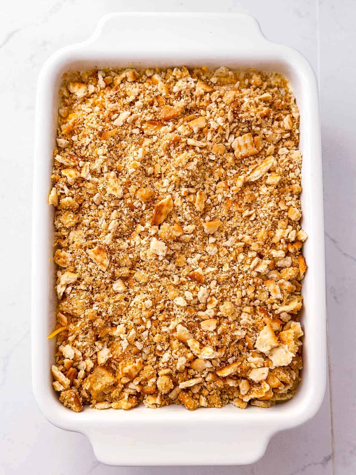 overhead view of unbaked casserole topped with buttery cracker crumbs