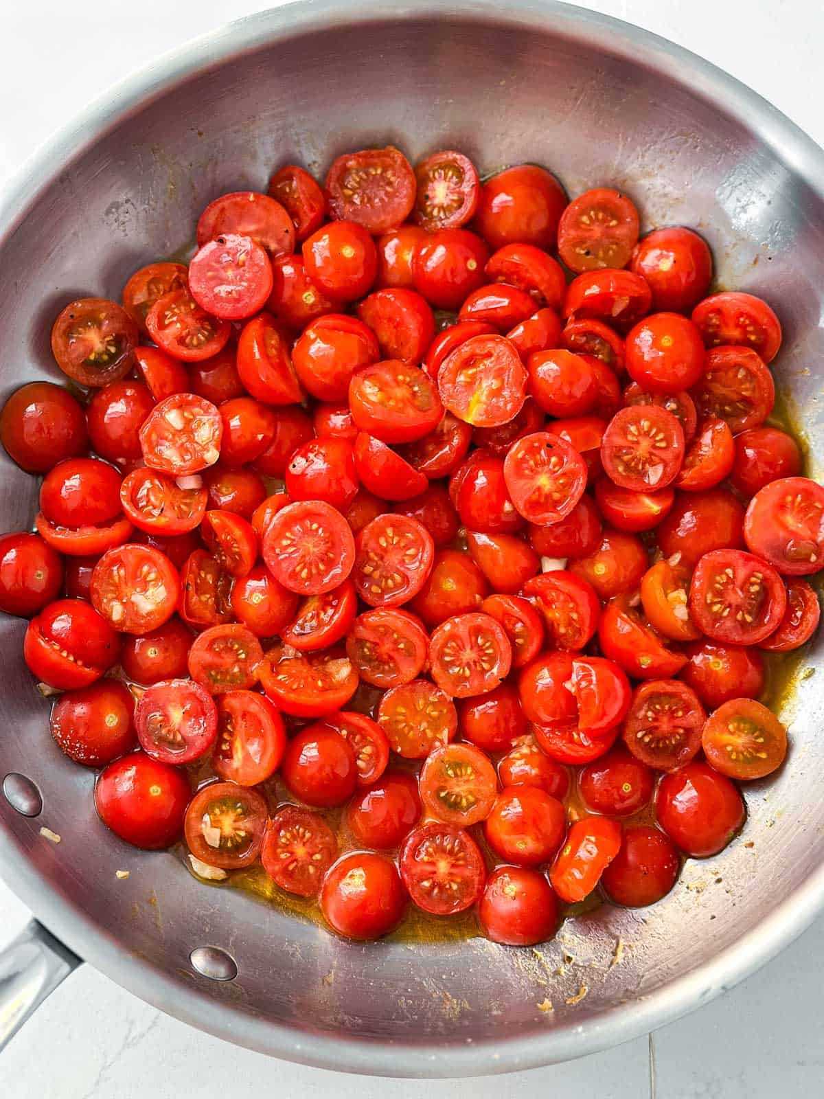 overhead view of sautéed tomatoes in skillet