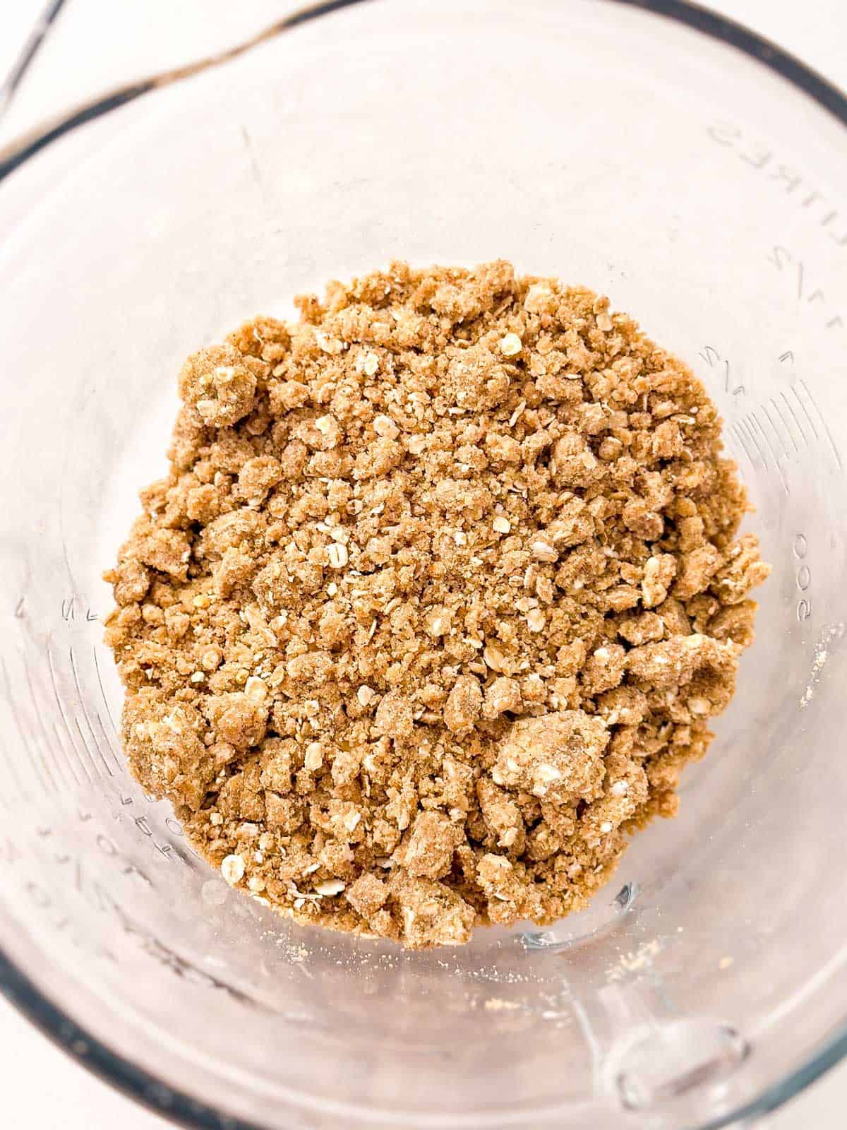 overhead view of glass bowl filled with oatmeal crumble topping