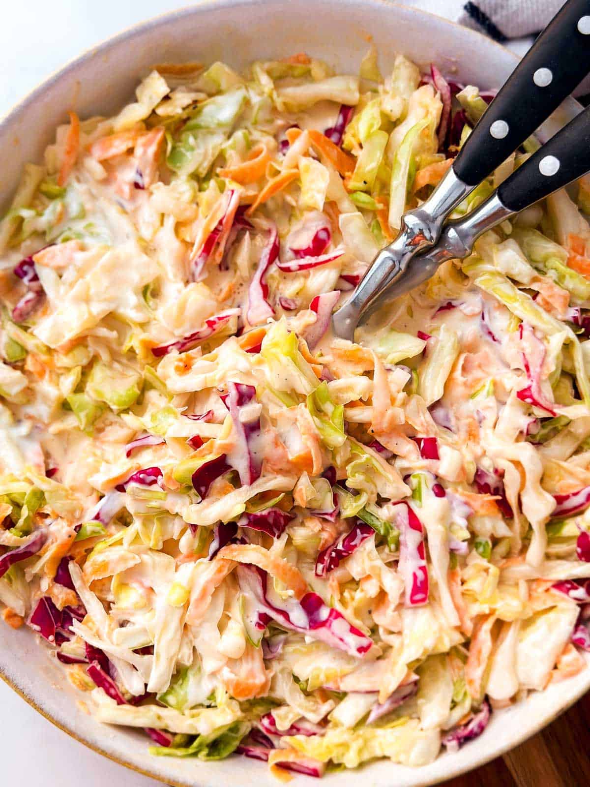 overhead view of white bowl filled with coleslaw