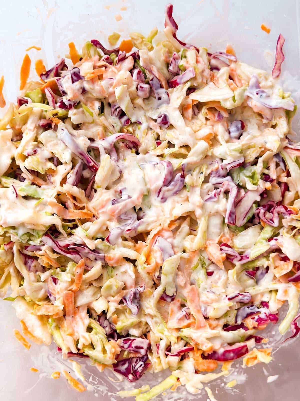 overhead view of chilled coleslaw in glass bowl