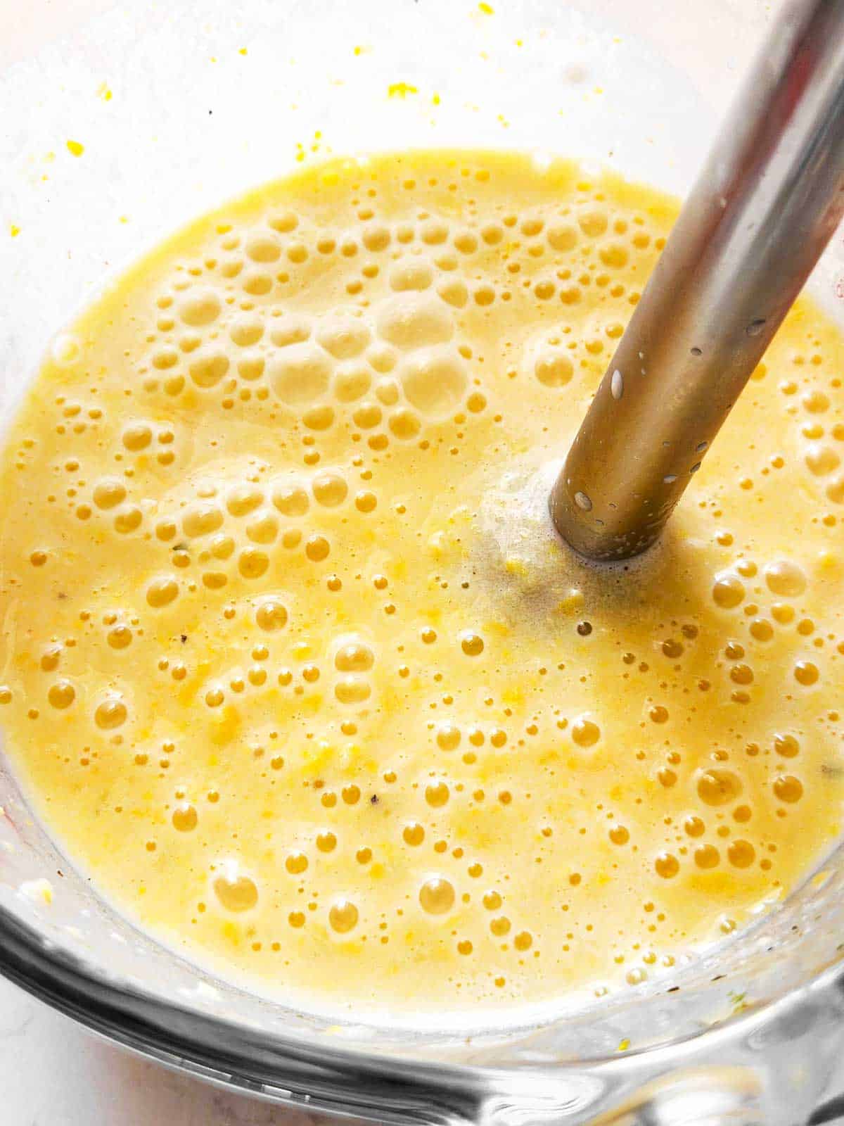 blender in glass jar filled with blended corn chowder