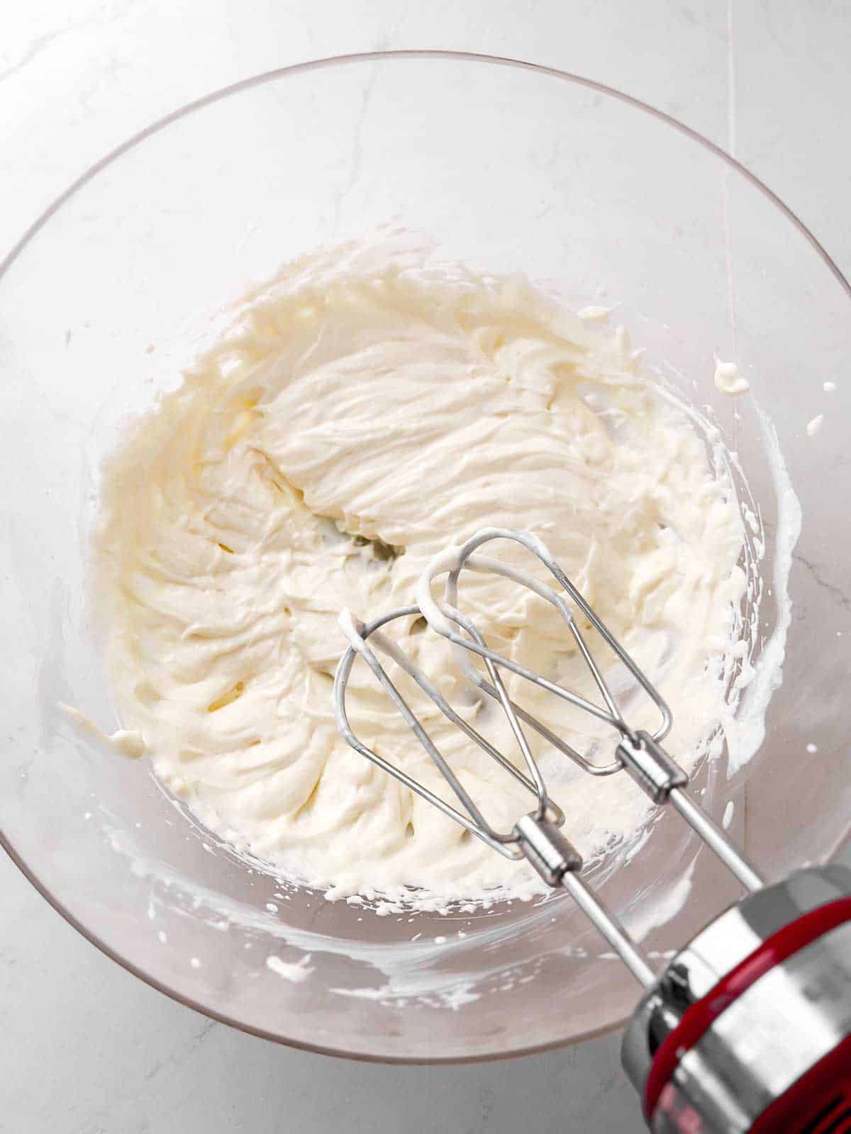 overhead view of grape salad dressing in bowl with mixer