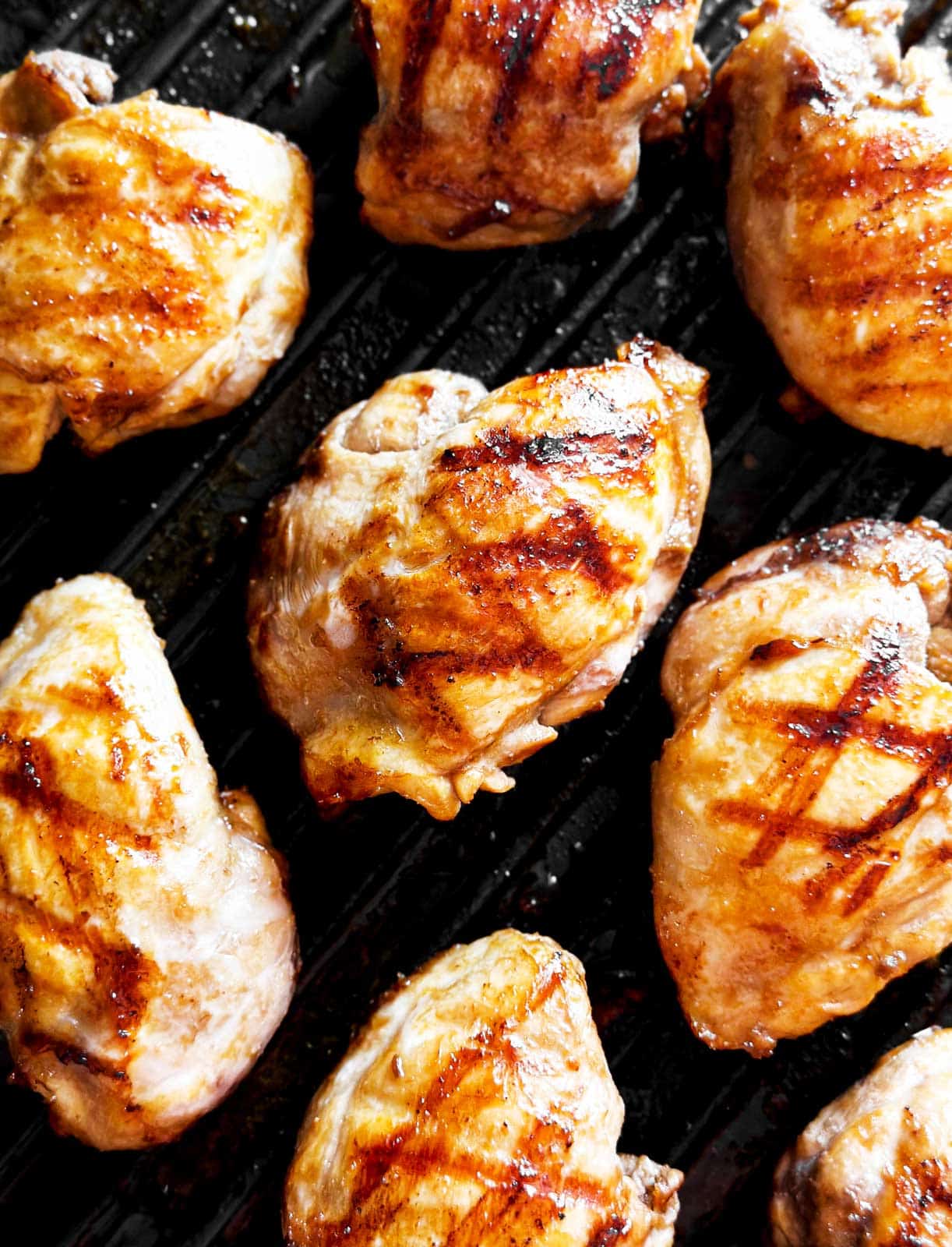 overhead view of chicken thighs on grill