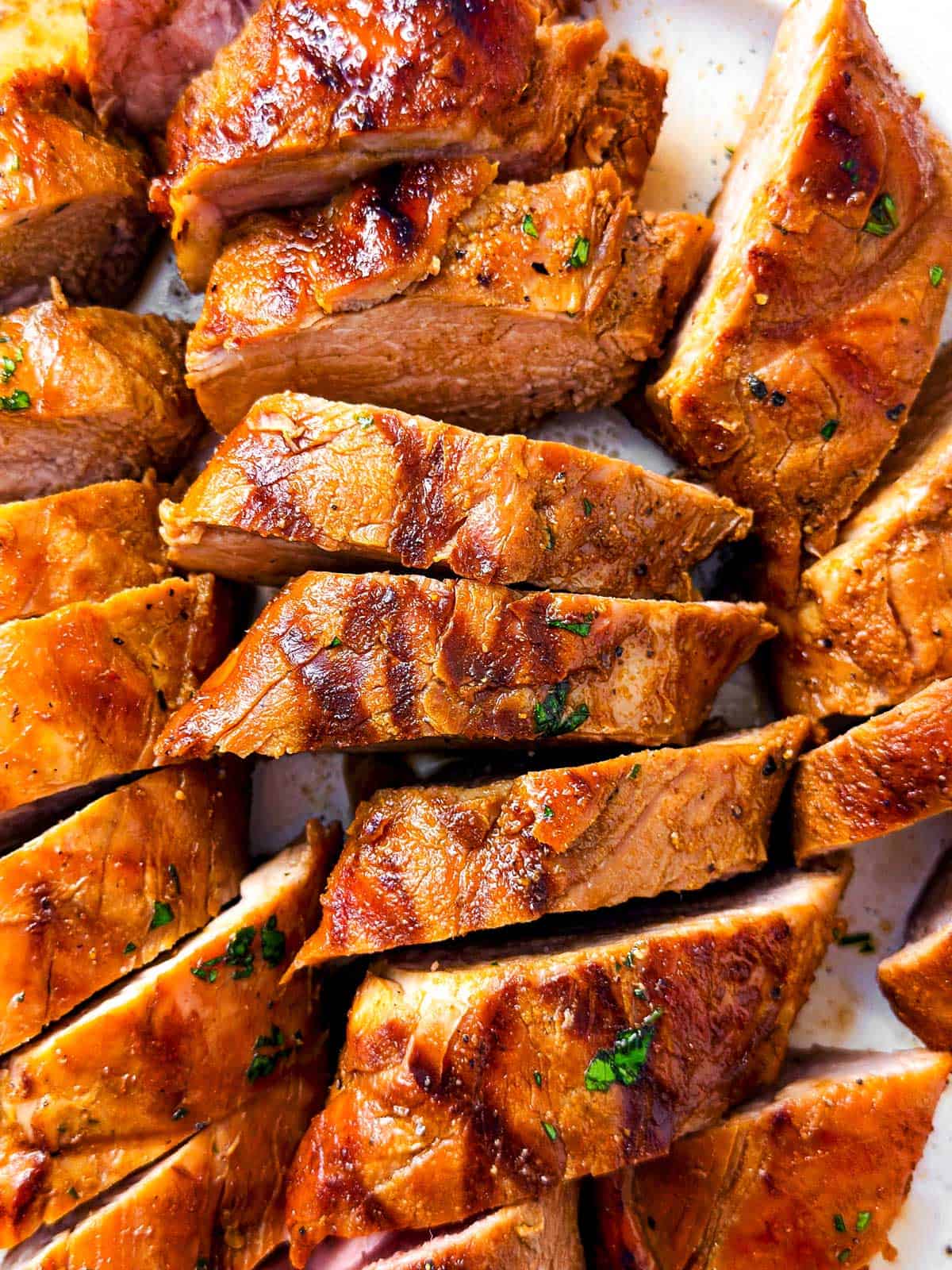 overhead close up view of grilled pork tenderloin sliced into medallions