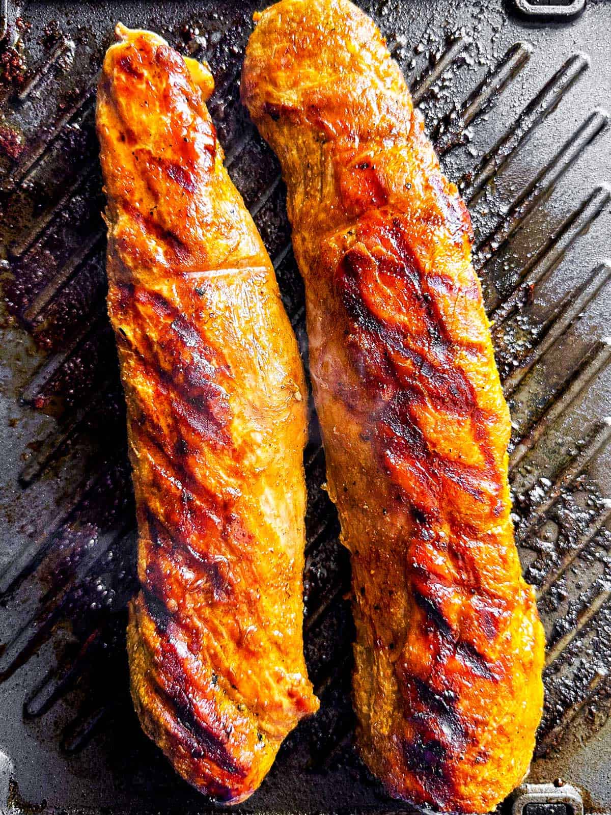 overhead view of cooked pork tenderloin on grill