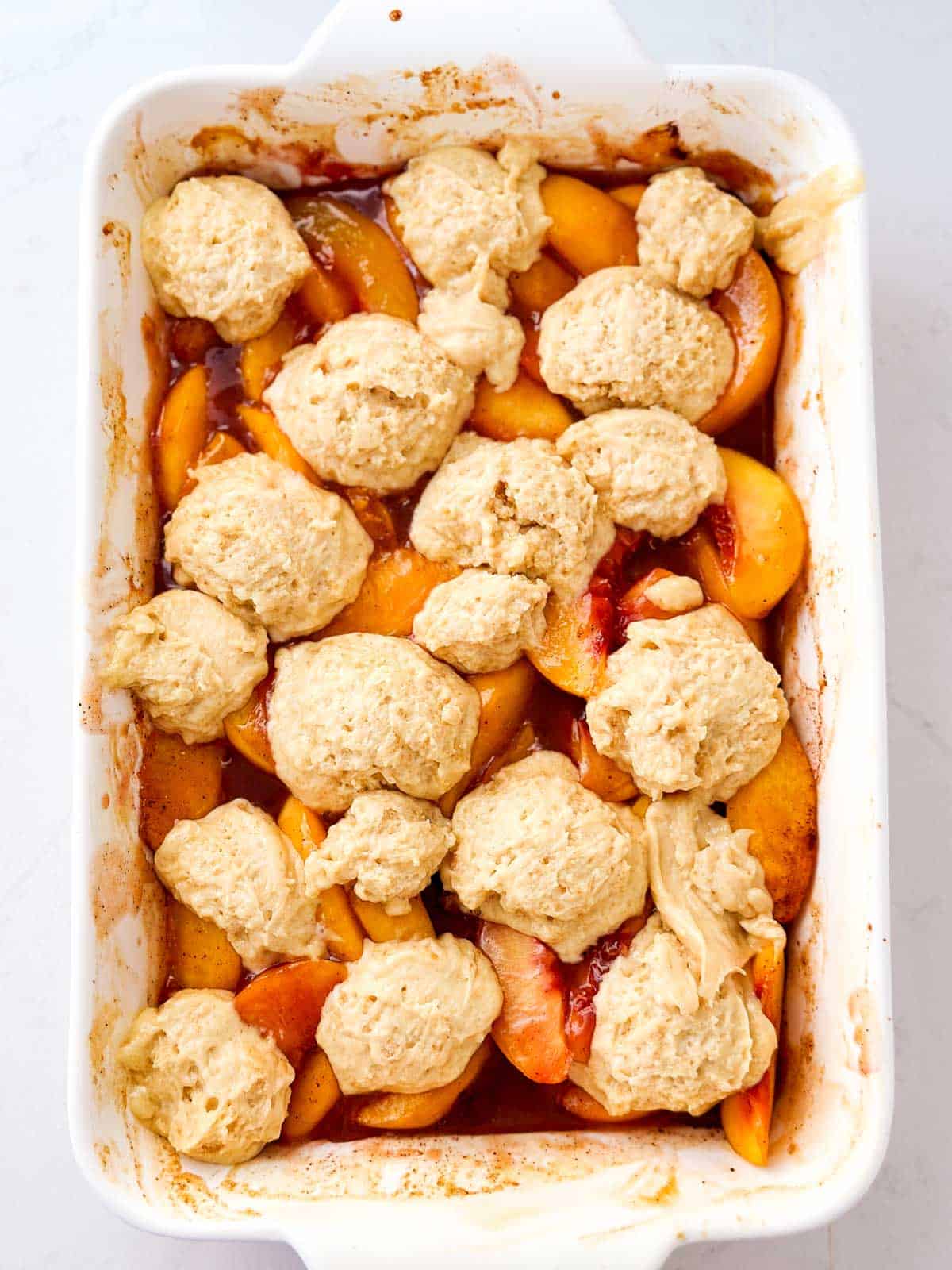 overhead view of unbaked peach cobbler