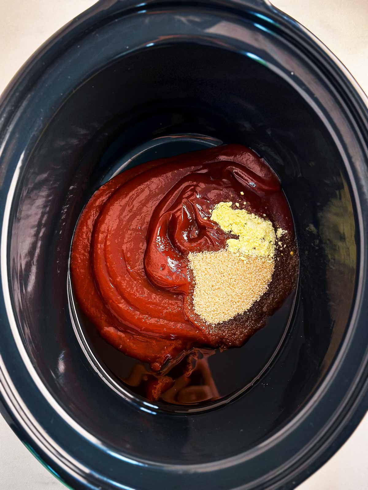 overhead view of bbq sauce and seasoning in crock