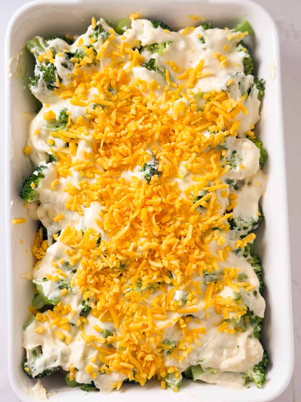 overhead view of unbaked broccoli cheese casserole