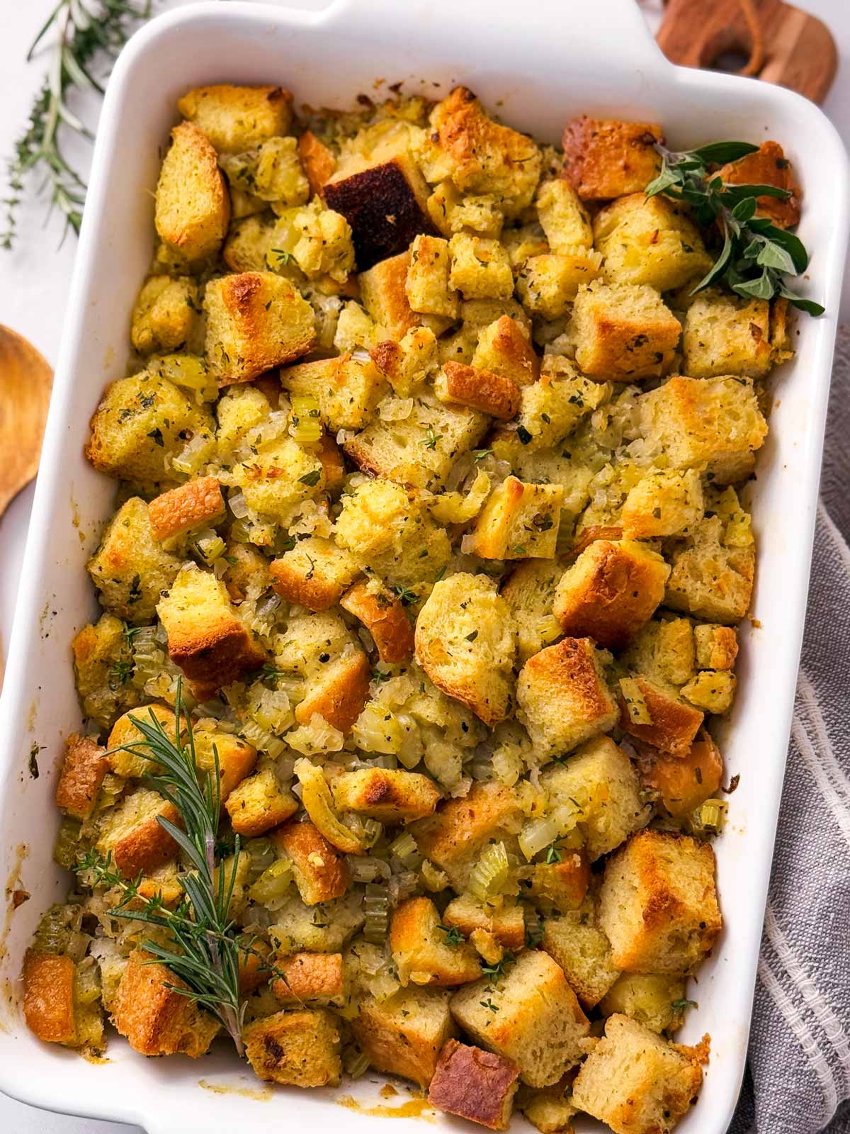 overhead close up view of baked stuffing in white casserole dish