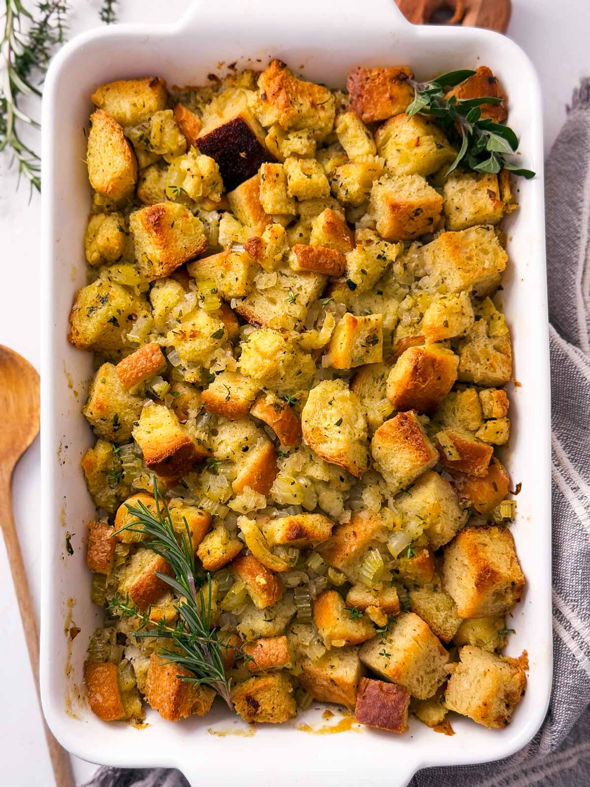 overhead view of freshly baked stuffing in white casserole dish