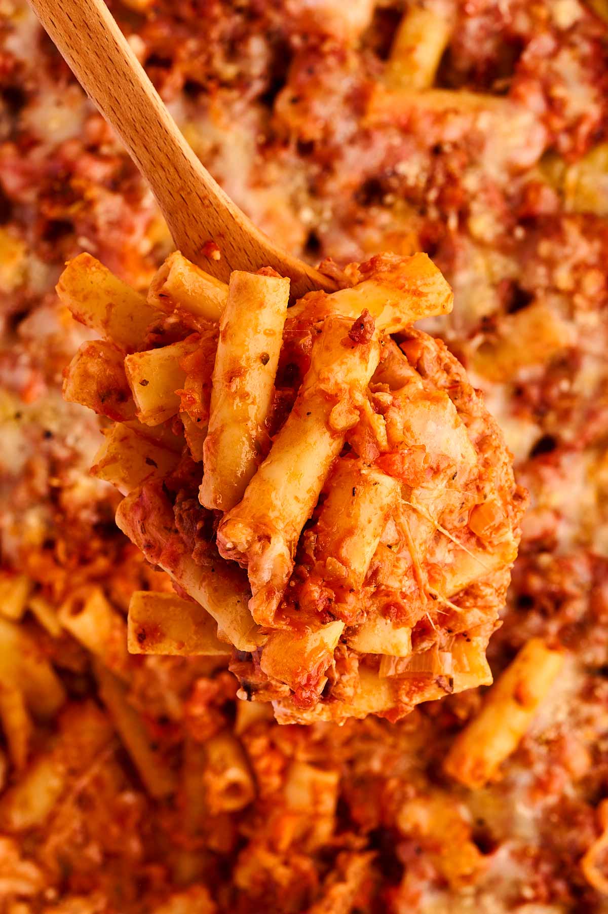 overhead view of baked ziti on wooden spoon